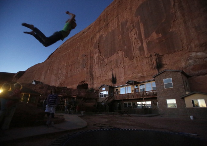 Girls play on a trampoline near a home blasted from a rock wall at the Rockland Ranch community outside Moab, Utah, November 2, 2012. The "Rock" as it is referred to by the approximately 100 people living there in about 15 families, was founded about 35 years ago on a sandstone formation near Canyonlands National Park. Polygamy was a part of the teachings of The Church of Jesus Christ of Latter-day Saints and was brought to Utah by faithful Mormons in the late 1840s.