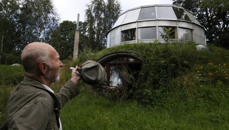Bohumil Lhota, a 73-year-old builder, stands in front of the house which he built in Velke Hamry, near the town of Jablonec nad Nisou, 100km (62 miles) north-east from Prague, August 7, 2012. Lhota conceptualized the idea to create the unique house and started to build it in 1981, building it close to nature to benefit from the cooler ground temperature. Lhota's house, which is built in 2002, is able to move up and down and rotate on its sides, which allows him to adjust to his preferred window view.