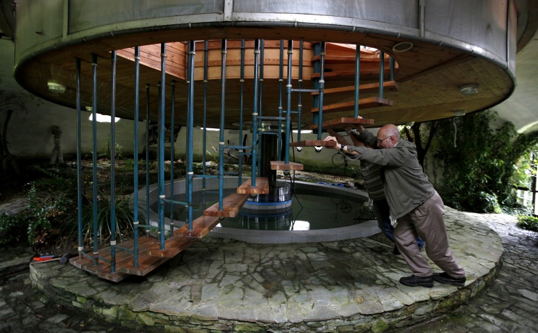 Bohumil Lhota, a 73-year-old builder, turns the house he built in Velke Hamry, near the town of Jablonec nad Nisou, 100km (62 miles) north-east from Prague, August 7, 2012. Lhota conceptualized the idea to create the unique house and started to build it in 1981, building it close to nature to benefit from the cooler ground temperature. Lhota's house, which is built in 2002, is able to move up and down and rotate on its sides, which allows him to adjust to his preferred window view.