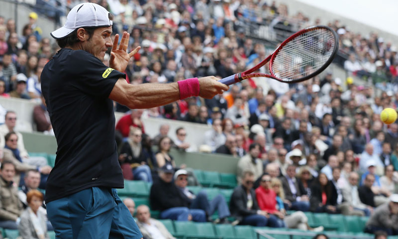 Germany's Tommy Haas hits a return to Russia's Mikhail Youzhny on his way to winning their French tennis Open round of 16 match at the Roland Garros stadium in Paris on June 3, 2013. — AFP Photo