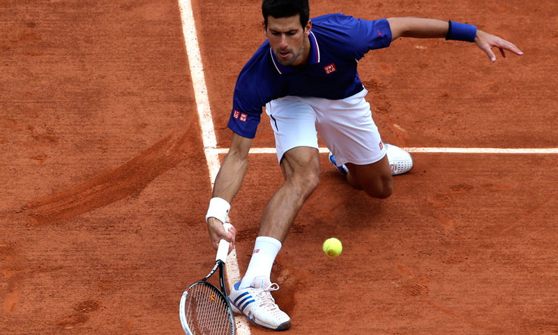Serbia's Novak Djokovic returns the ball to Germany's Philipp Kohlschreiber during their fourth round match of the French Open tennis tournament at the Roland Garros stadium Monday, June 3, 2013 in Paris. — AP Photo