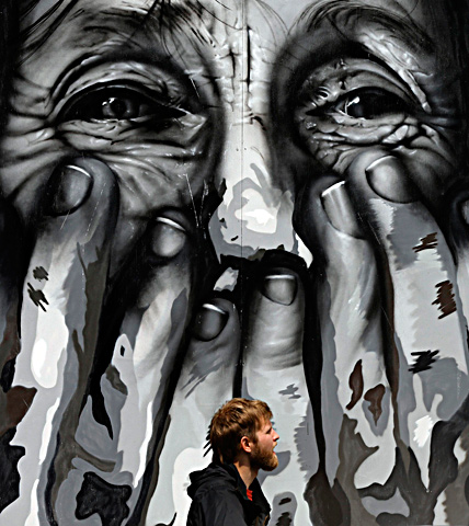A mural in progress is seen on the side of a building during the Mural Festival on June 6, 2013 in Montreal, Canada. — AFP Photo