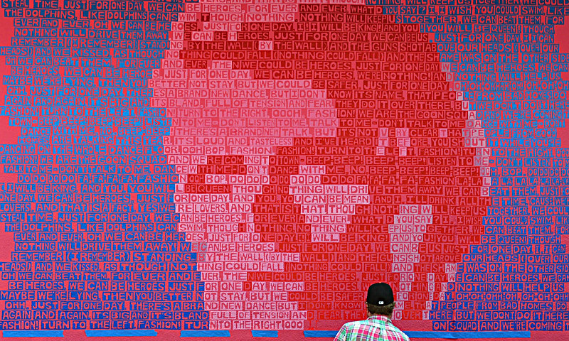 Mural artist Erik Den Breejen works on his creation "FashionHeroesBowie" in New York on June 18, 2013. — AFP Photo