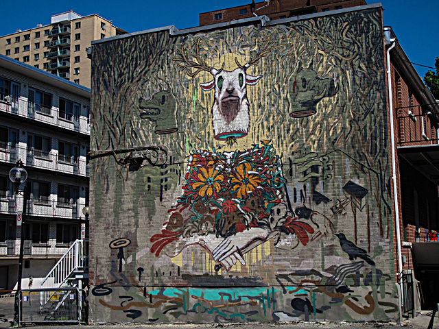 A mural is seen on the side of a building during the Mural Festival on June 6, 2013 in Montreal, Canada. The festival is the first of its kind in Canada, an open-air museum featuring work by some 35 artists from around the world. — AFP Photo