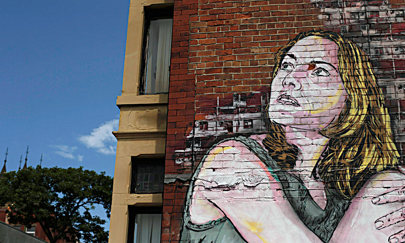 A man uses his phone to take a photograph of a mural on the wall of a car park in Blackpool, northern England June 18, 2013. The mural is part of the "Sand, Sea and Spray" outdoor art festival, which has seen 40 urban artists from around the world paint murals on buildings across the town centre. — Reuters Photo