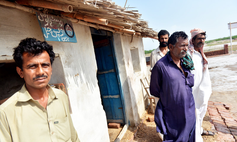 Usman Khaskheli (left) with ASI, Dodho Khan Paryal (right). -Photo by Fahim Siddiqi / White Star