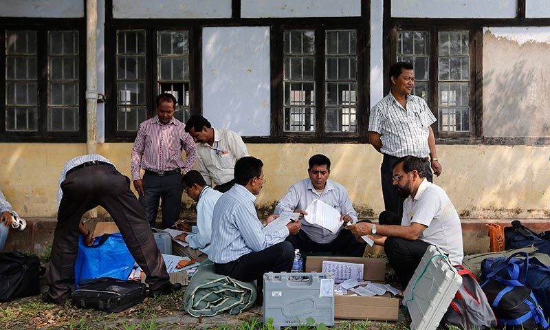 Polling officers check the election material after collecting them from a distribution centre ahead of general elections in Jorhat district, in the northeastern Indian state of Assam. —Photo by Reuters