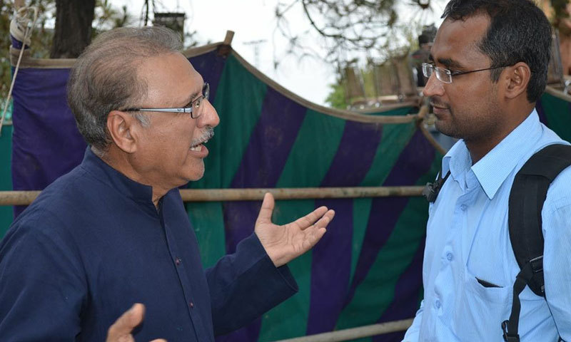 PTI leader Arif Alvi tells our correspondent that the rally took time to start because the workers are still pouring in to D-Chowk for the protest.—Photo by Irfan Haider