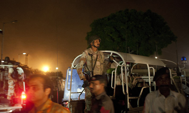 Pakistani security troops rush to Karachi airport terminal following attacks by unknown gunmen. -AP Photo