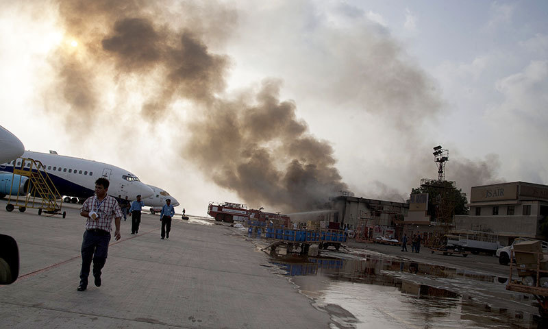 Smoke rises above Karachi airport terminal Monday, June 9, 2014 in Pakistan. — Photo by AP