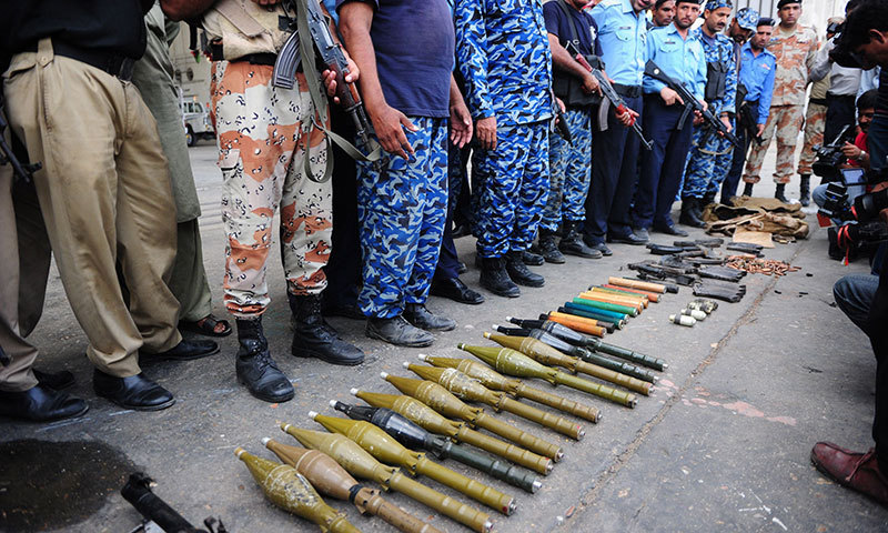 Policemen show seized weapons after militants attacked Jinnah International Airport in Karachi on June 9, 2014. — Photo by AFP