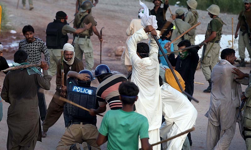 Pakistani protesters beat a police officer during a clash in Islamabad, Pakistan, Monday, Sept. 1, 2014. — Photo by AP