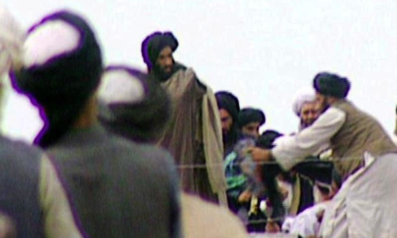 This television frame grab from 1996 taken secretly by BBC Newsnight shows Taliban's spiritual leader Mullah Mohammed Omar, center, in Kandahar in 1996. &mdash; AFP/file
