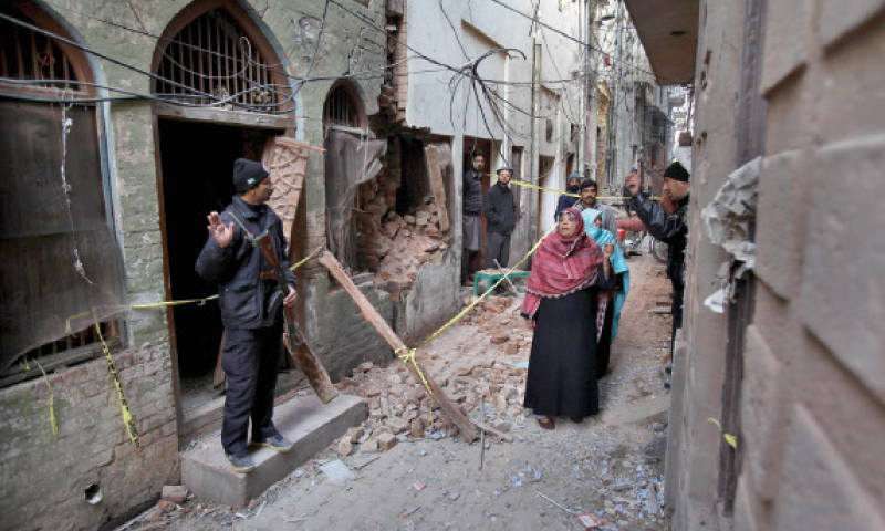 Police officers stand guard at the site of Friday’s suicide bombing outside the imambargah in Rawalpindi.  — AP