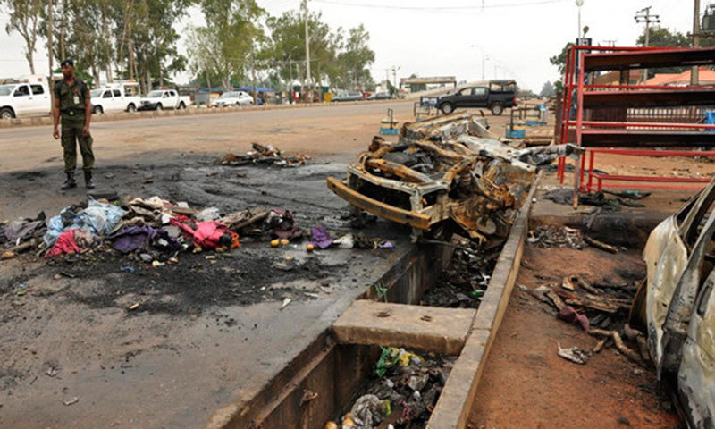 In this photo, a policeman stands next to the point of impact of a suicide bomb in Kano. — Reuters/File