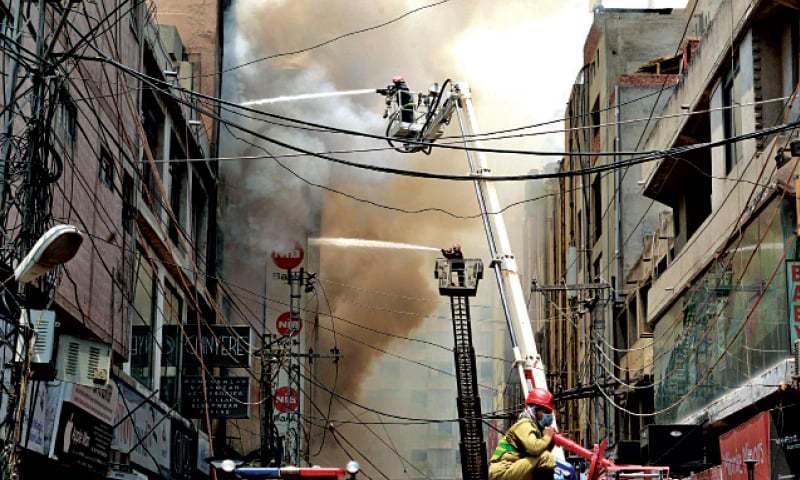 Firefighters try to extinguish the blaze which engulfed Al-Fatah Department Store in Liberty Market. — White Star