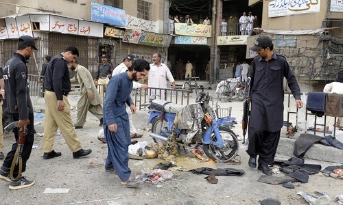 Security personnel gather around the site of the bomb explosion. – AFP/File