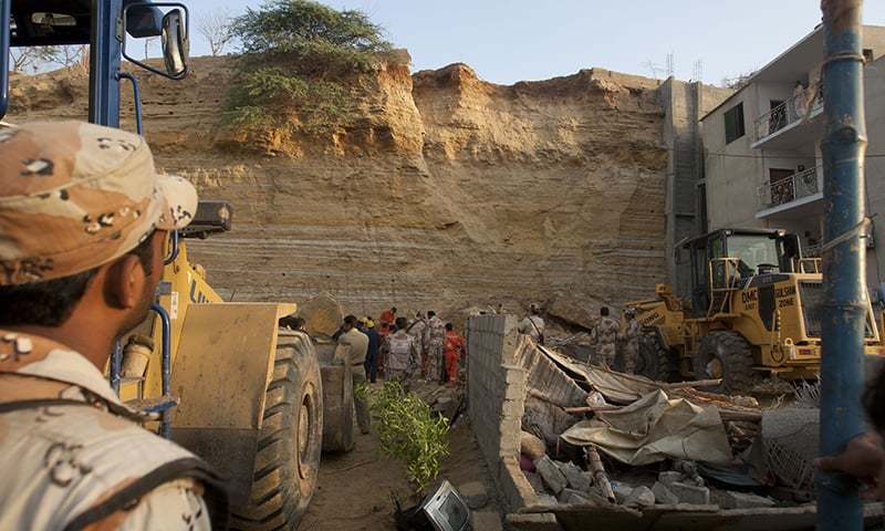 A Rangers man surveys the destruction caused by the rockslide. ─ White Star