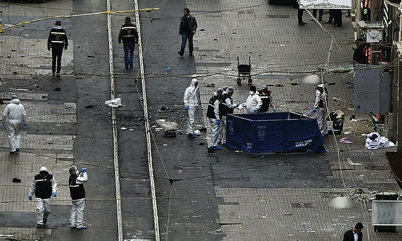 Security and forensic officials work at the explosion site in Istanbul. ─ AP