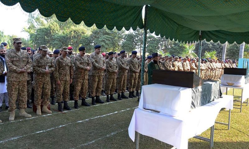 Gen Raheel Sharif and military officials offer funeral prayers for soldiers who were killed in cross-border firing at the LoC. —AFP