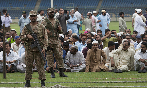 Soldiers stand guard as people wait for the funeral of  Abdul Sattar Edhi in Karachi Saturday, July 9, 2016.— AP