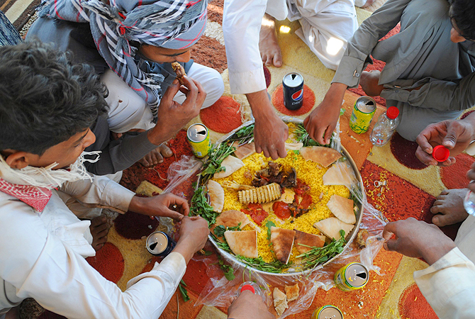A traditional dish known as Kabsa is seen with a tail of an Uromastyx lizard, also known as a dabb lizard, in a desert near Tabuk.—Photo by Reuters