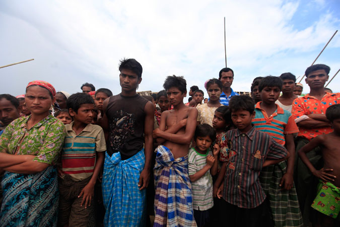 Thandawli villagers listen as they are briefed by UN and government officials about cyclone Mahasen at a Rohingya internally displaced persons (IDP) camp outside of Sittwe. —Reuters Photo