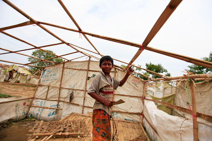 A boy dismantles his tent before moving to safer grounds in light of an approaching cyclone, in an Internally Displaced Persons (IDP) camp for Muslims, outside Sittwe. —Reuters Photo