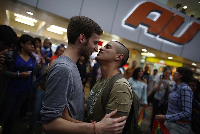 A gay couple embrace during a protest to mark International Day Against Homophobia and Transphobia in Mexico City. Gay rights activists staged a "kissathon" at the TAPO bus station to protest against police officers that harassed a lesbian couple kissing at the station on May 13, local media reported.—Photo by Reuters