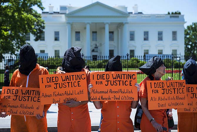 Activists stand on Pennsylvania Avenue during a protest outside of the White House in Washington on the 100th day of a hunger strike at Guantanamo Bay to protest the military prison where the United States has been holding suspects captured in the so-called war on terrorism.—Photo by AFP
