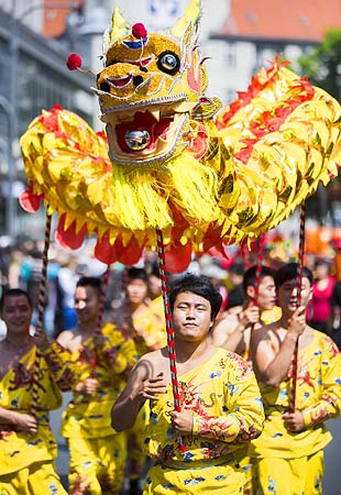 Dancers representing China perform with a dragon during the Carnival Of Cultures parade in Berlin, Germany.—Photo by AP