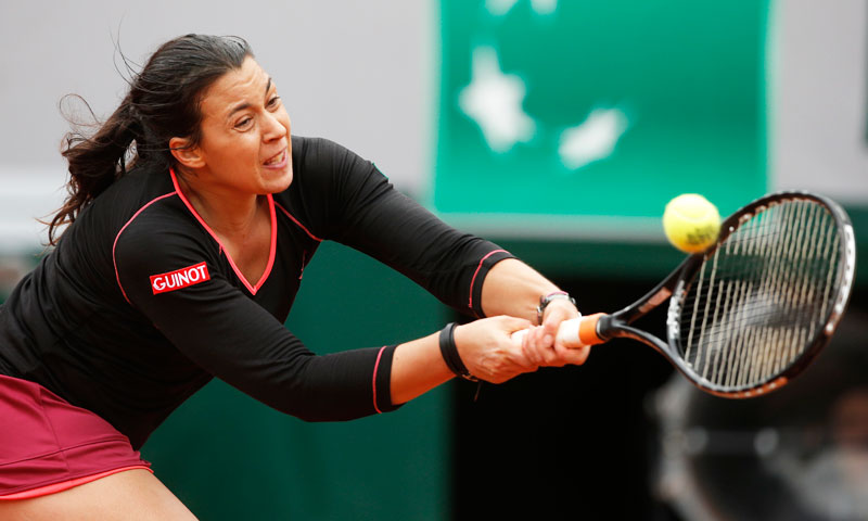 France's Marion Bartoli returns the ball to Olga Govortsova, of Belarus, during their first round match. —AP Photo