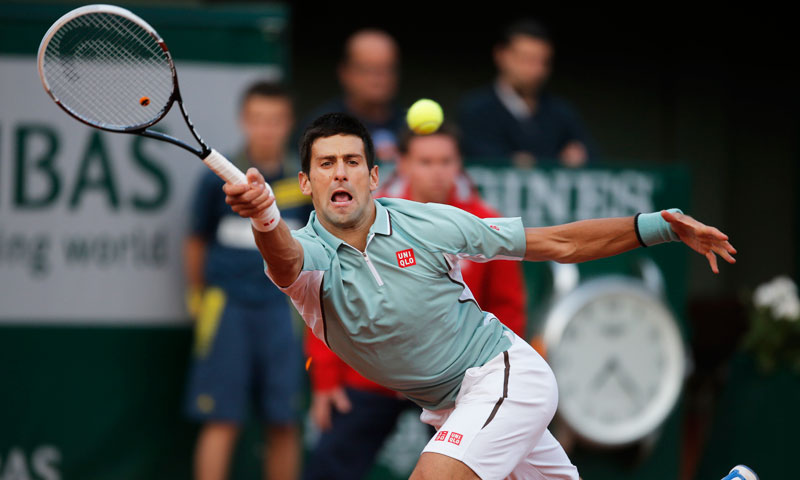 Serbia's Novak Djokovic returns against David Goffin of Belgium during their first round match at the French Open tennis tournament. He defeated Goffin with 7-6 (5), 6-4, 7-5. —AP Photo