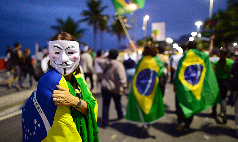Demonstrators protest for better public services, a new political system and against the Brazilian PEC37 draft law, a proposed constitutional amendment that would take away the power of independent public prosecutors to probe crimes making it harder to combat corruption, on Copacabana in Rio de Janeiro. The protests come as Brazil hosts a dry run for the World Cup, called the Confederations Cup.—Photo by AFP