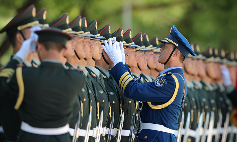 Chinese honour guards await the arrival of Pakistan's Prime Minister Nawaz Sharif. — AFP Photo