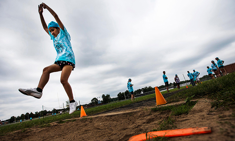 Dah Ku participates in long jump at Camp Abilities in Brockport, New York.