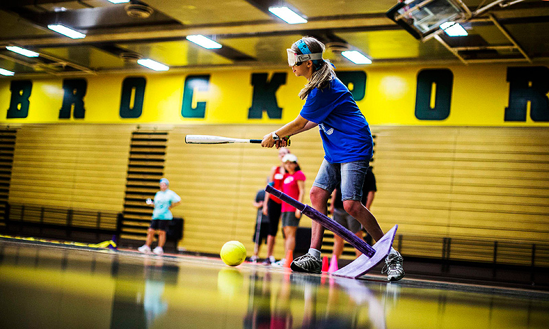 Anastasia Gian swings the bat as she plays "beep" baseball at Camp Abilities in Brockport, New York.