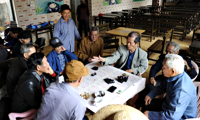 A group of elderly men playing at a tea house.