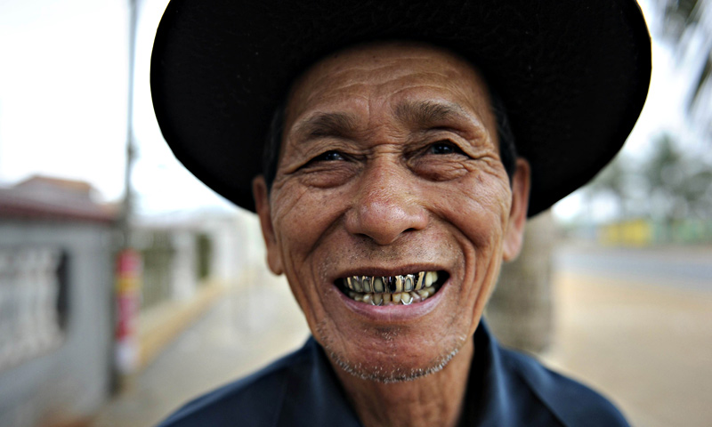 An elderly man laughing outside at a tea house in Chengmai city, in China's southern Hainan province.