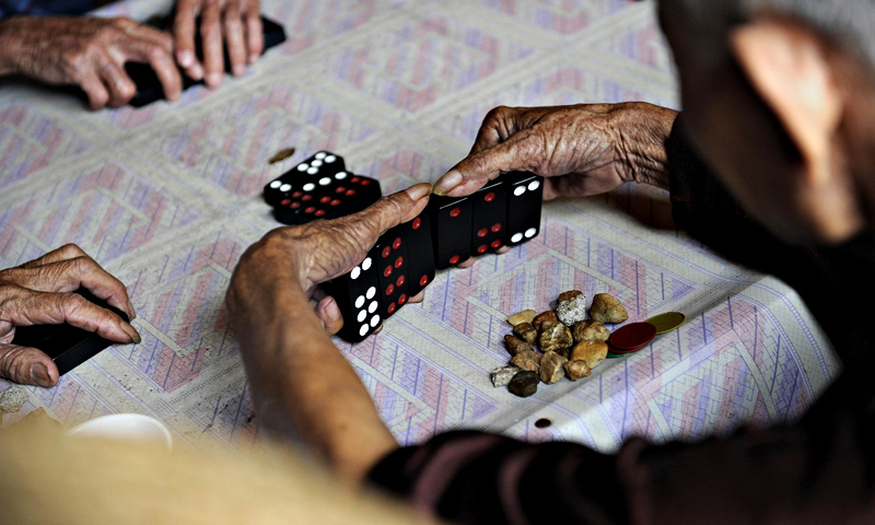 A group of elderly men playing at a tea house in Chengmai city.