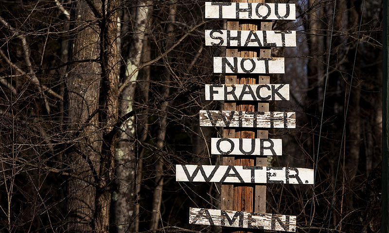Signs protesting the process of hydraulic fracturing, also known as fracking, are seen near the town of Calicoon Center, New York. The oil and gas industry is finding that less is more in the push to treat and recycle water used in the hydraulic fracturing process.—Photo by Reuters