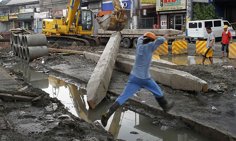 Labourers work on ongoing road repairs along a main street at Mandaluyong city, metro Manila. The Philippines, the former "sick man" of Asia, has fortified its economy, positioning it to weather storms engulfing the region's vulnerable emerging markets and to snap back faster when global growth recovers.—Photo by Reuters