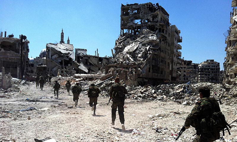 Syrian government forces patrol in the Khalidiyah neighbourhood of the central city of Homs. Government forces bolstered by Lebanese Shia militiamen were poised to retake the largest rebel-held district of Syria's third city Homs, a watchdog and state media said. — AFP Photo