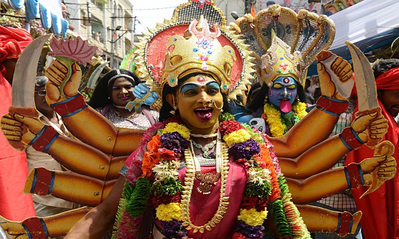 An Indian Hindu devotee dressed as the Hindu Goddess Maha Kali performs in the street during the Bonalu festival at the Sri Ujjaini Mahakali Temple in Secunderabad, the twin city of Hyderabad. The Goddess Kali is honoured mostly by women during Bonalu festival by offerings of food and dancing. — AFP Photo