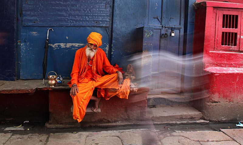 An Indian Hindu holy man rests in an alleyway in Varanasi. Varanasi is among the world's oldest continuously inhabited cities, and one of the most important pilgrimage centers for Hindus who gather here for ritual bathing and prayers on the banks of the Ganges. — AP Photo