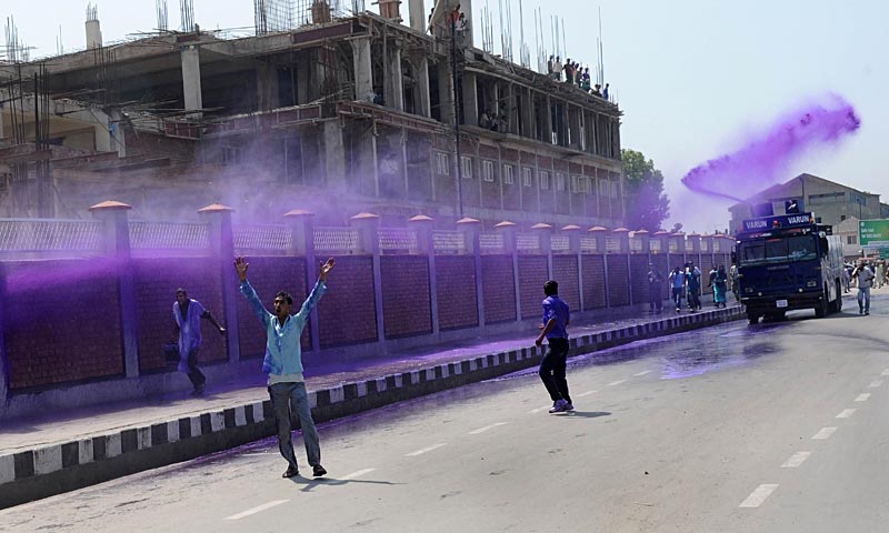 Kashmiri government employees are sprayed with purple-dye water cannon by riot police during a demonstration in Srinagar. Dozens of government employees were arrested as they tried to stage a protest march in Srinagar demanding a regularisation of contractual jobs and an increase in salary. — AFP Photo