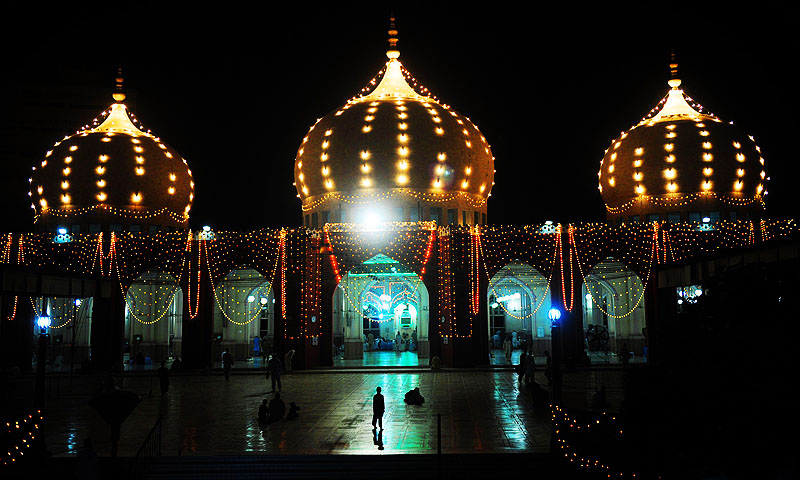 Worshippers arrive at the illuminated Mamon Mosque for special prayers in Karachi, during Lailat ul-Qader, also known as the Night of Power, the 27th night of the Holy month of Ramadan.—Photo by AFP