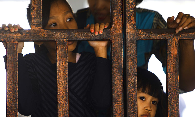 Children wait for their train to arrive, which will take them back to their hometown, ahead of the Muslim Eidul Fitr holiday, at Pasar Senen train station in Jakarta.—Photo by Reuters