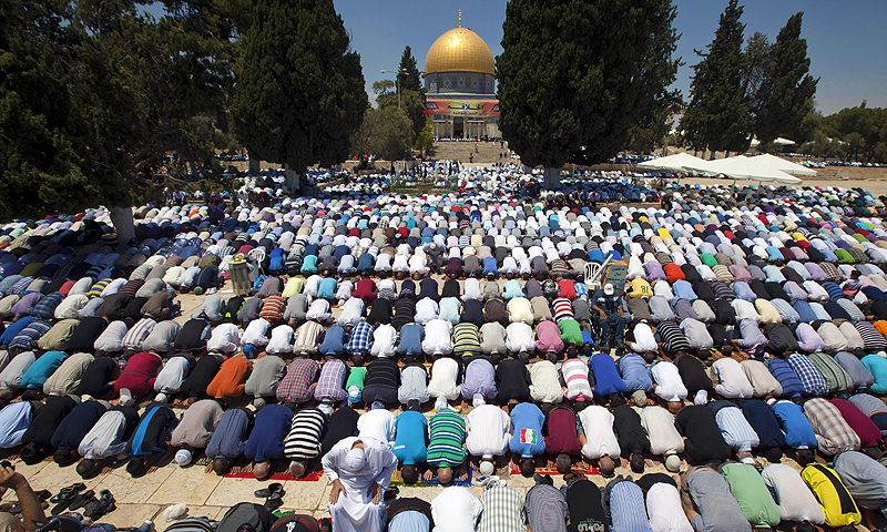 Palestinian worshipers pray outside the Dome of the Rock at the Al-Aqsa Mosque compound in Jerusalem. — AFP Photo