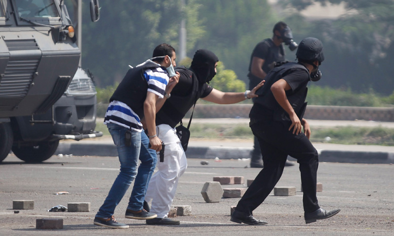 Police officers move in to contain Mursi’s supporters.